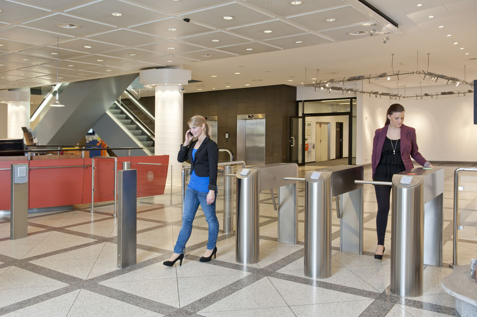 people passing through mid level turnstiles 